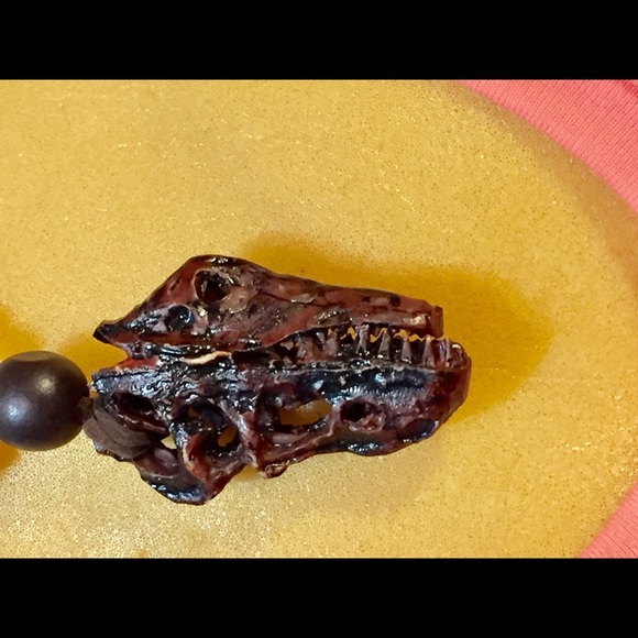 Other - A carved dinosaur head wood necklace